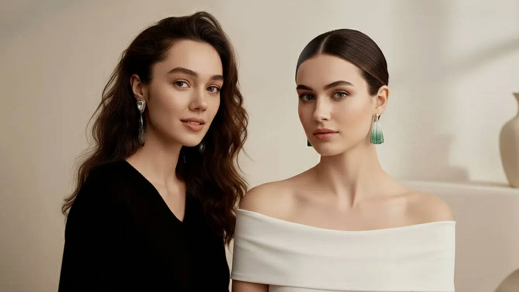 Two elegant women modeling earrings, left wearing drop-shaped diamond gradient earrings, right with green tassel earrings, black and white outfits creating a fashionable ambiance.