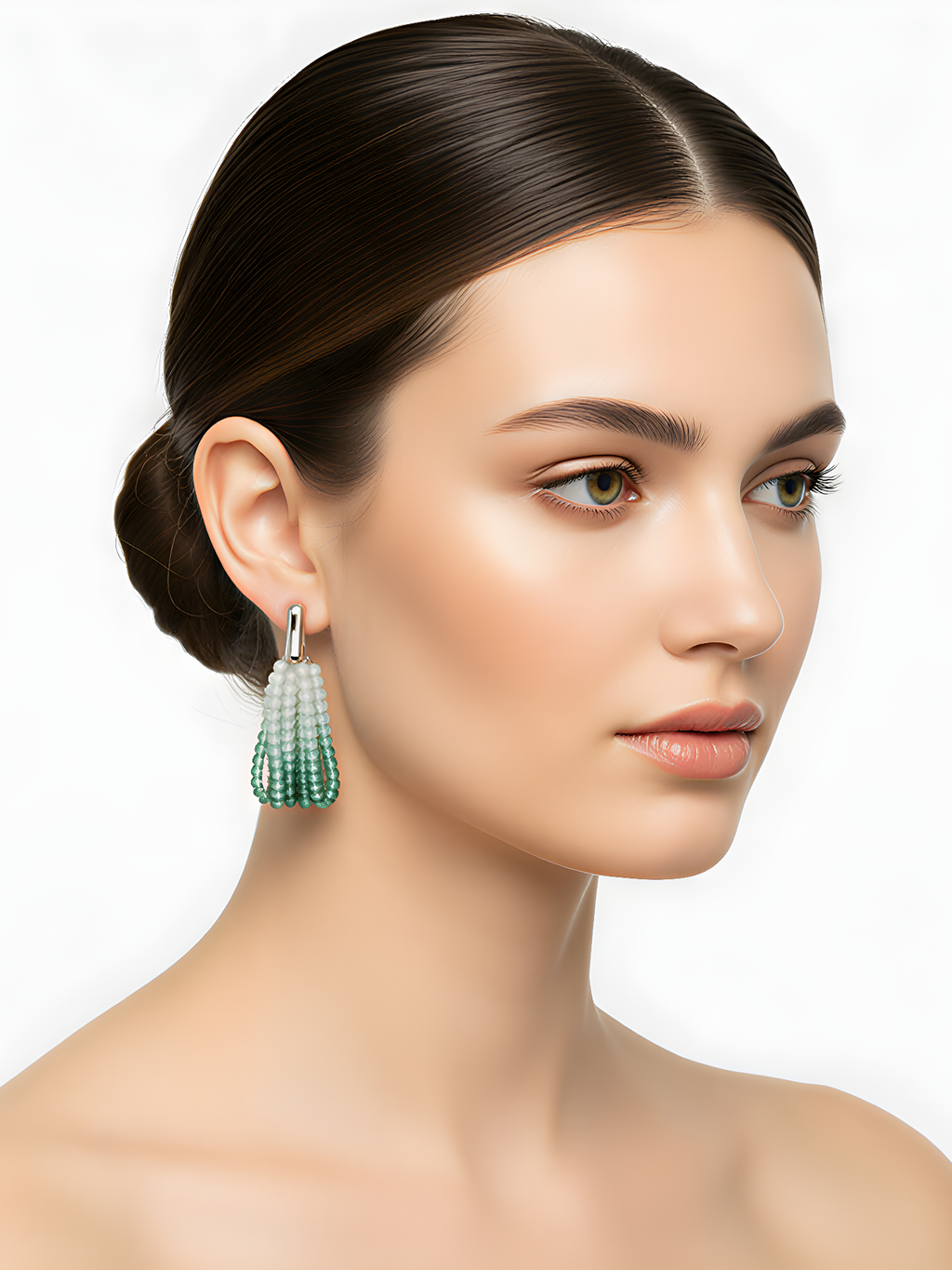 Side profile of a woman with a sleek bun, showcasing the elegant drape of the blue-green gradient beaded earring.