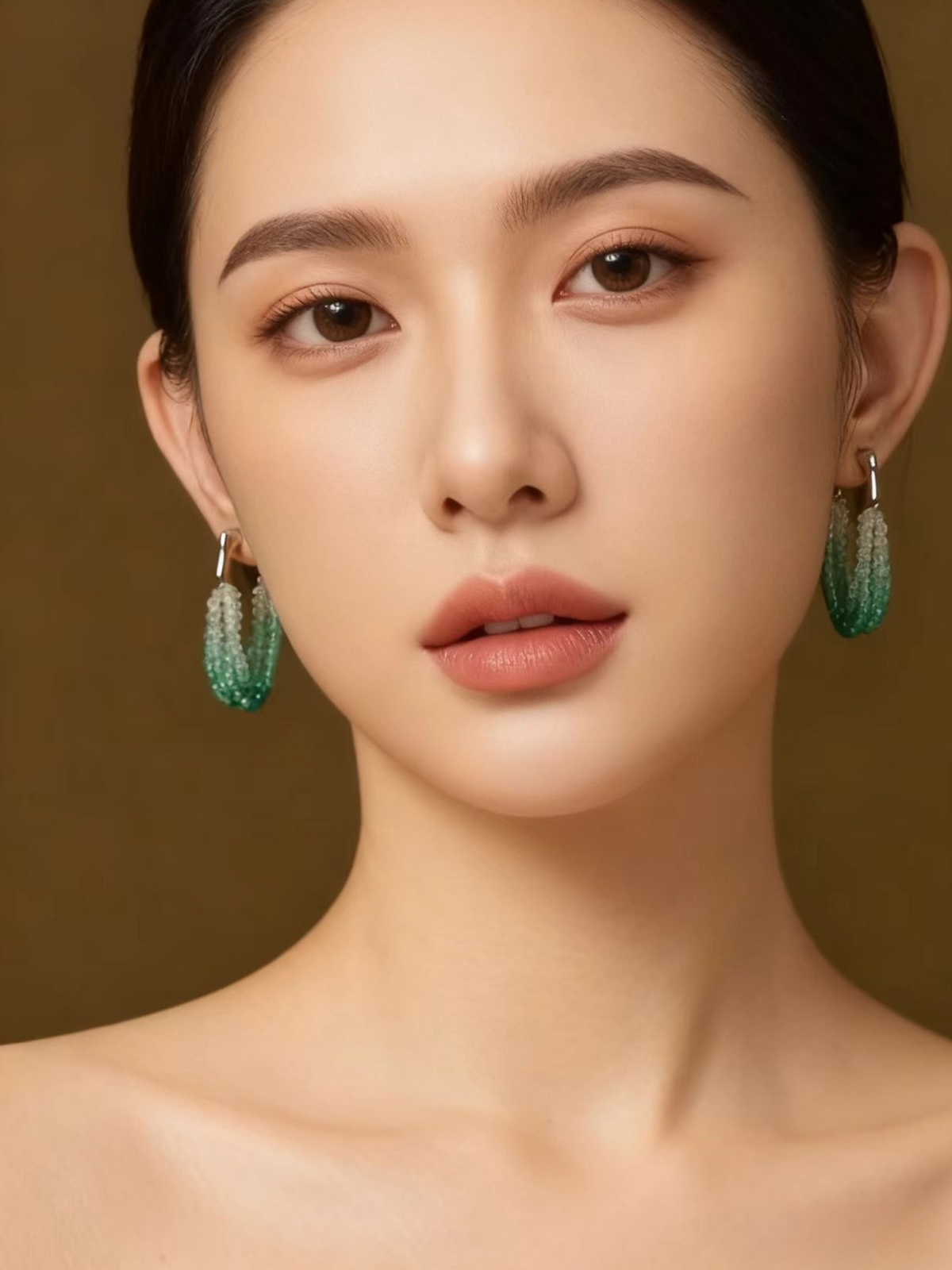 Close-up portrait of a woman elegantly wearing the multi-strand gradient aqua bead drop earrings.