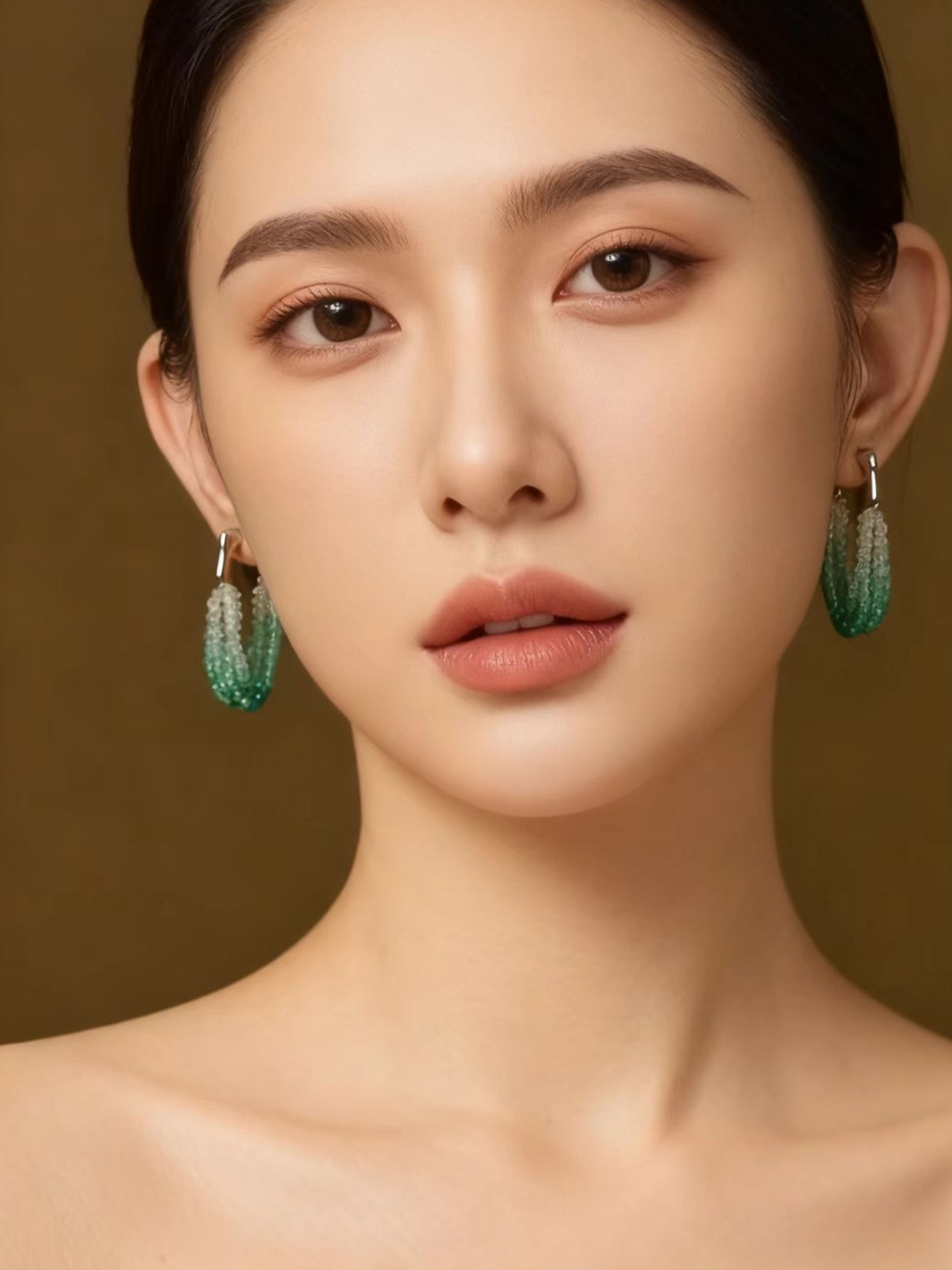 Close-up portrait of a woman elegantly wearing the multi-strand gradient aqua bead drop earrings.