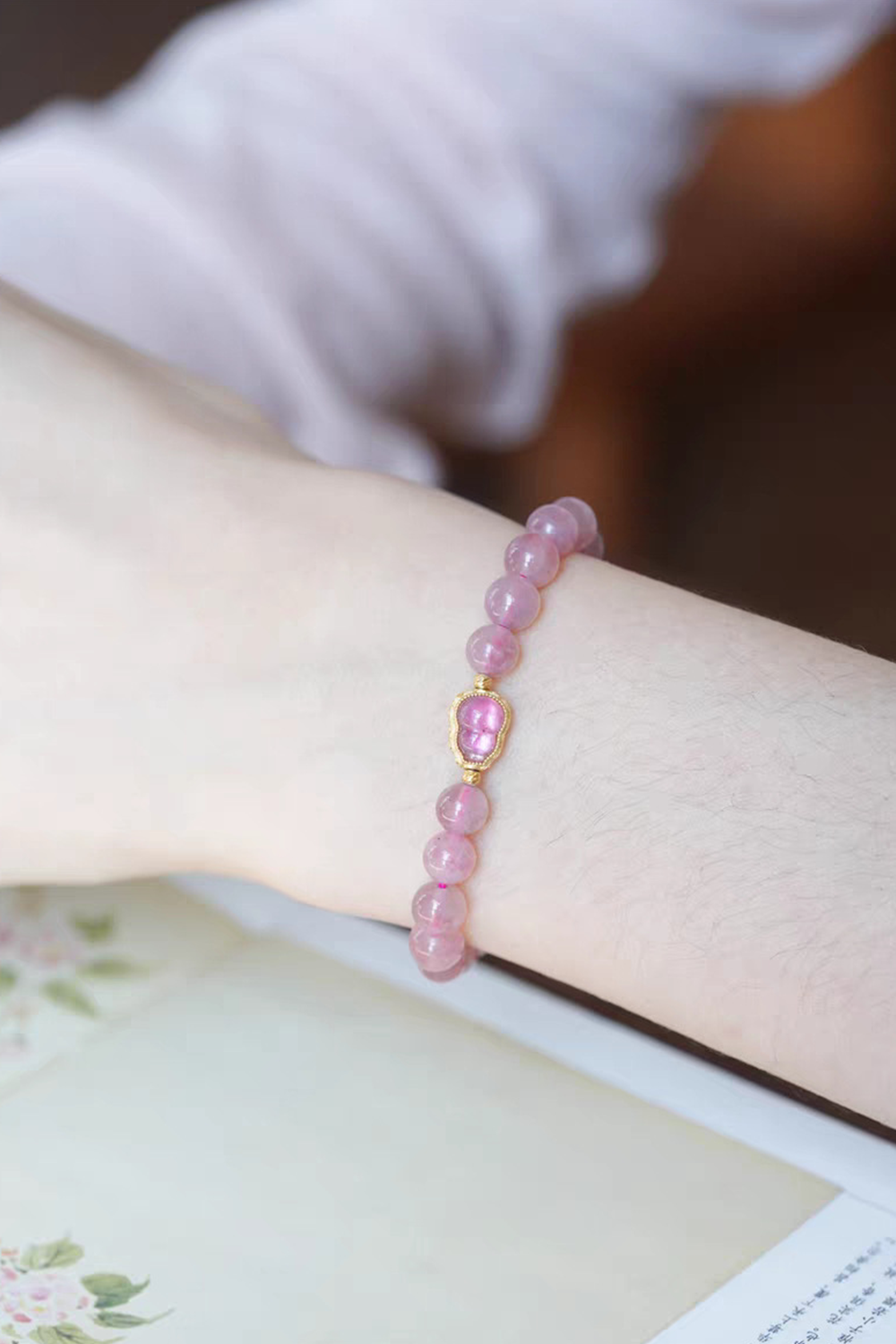 Floating Pink Gemstone Accented Gold Frame Gracing Fair-Skinned Wrist | Seysage