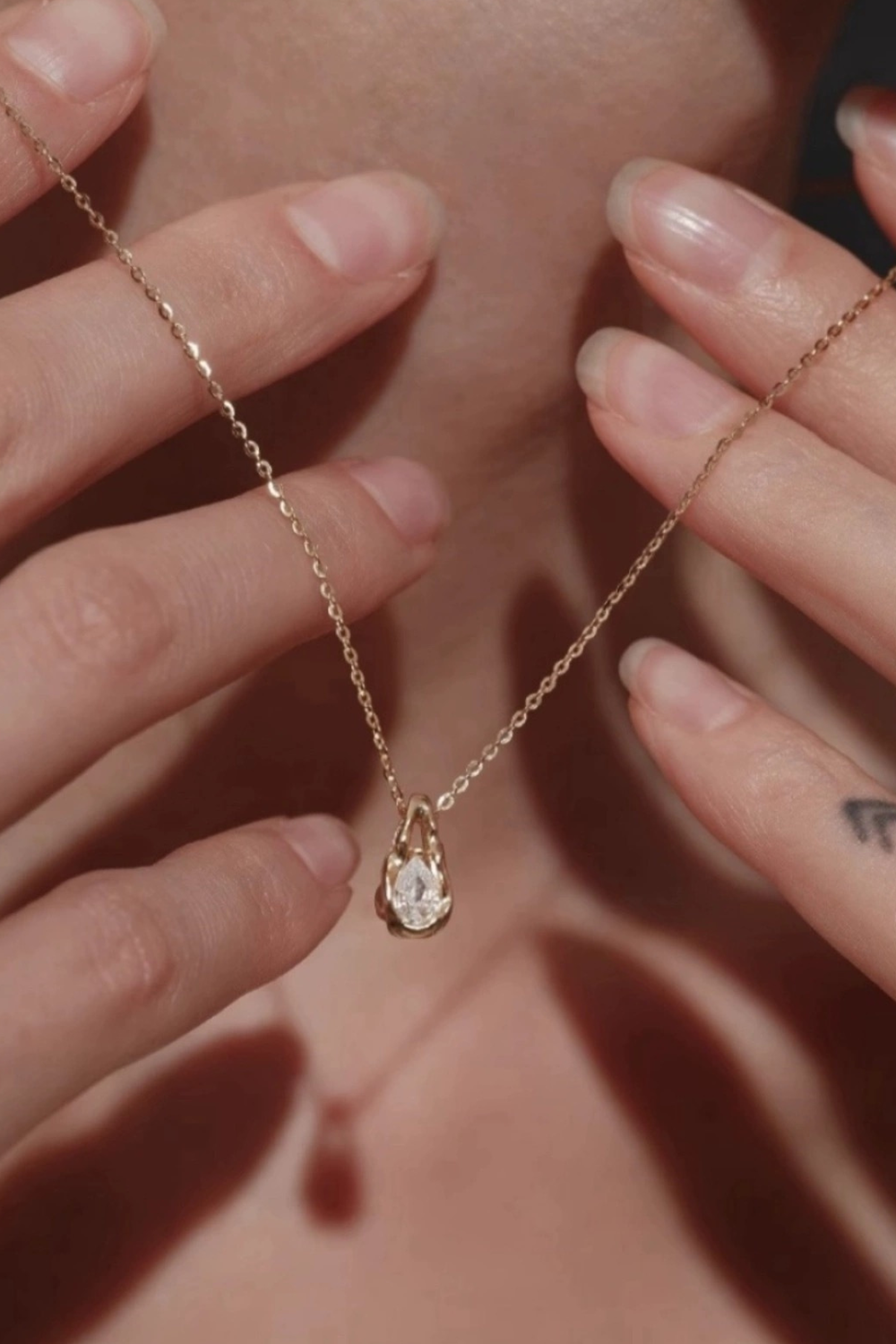 Rose Gold Faceted Teardrop Shining in Hands | Seysage