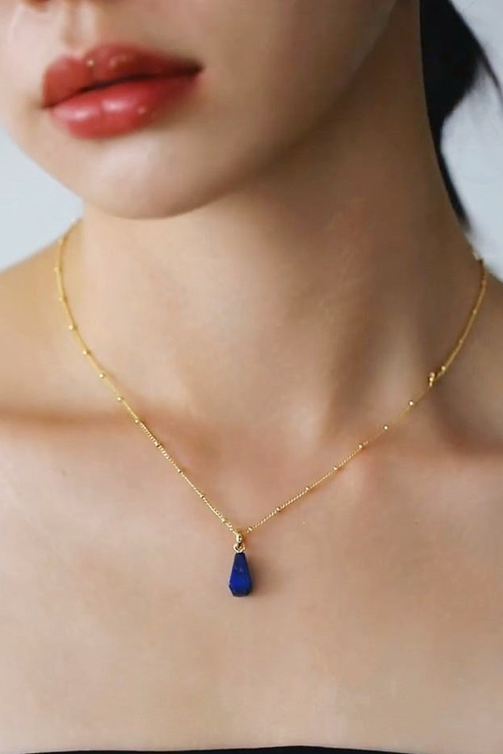 Sapphire Teardrop Necklace Radiating on Fair Skin Against Red Lips | Seysage