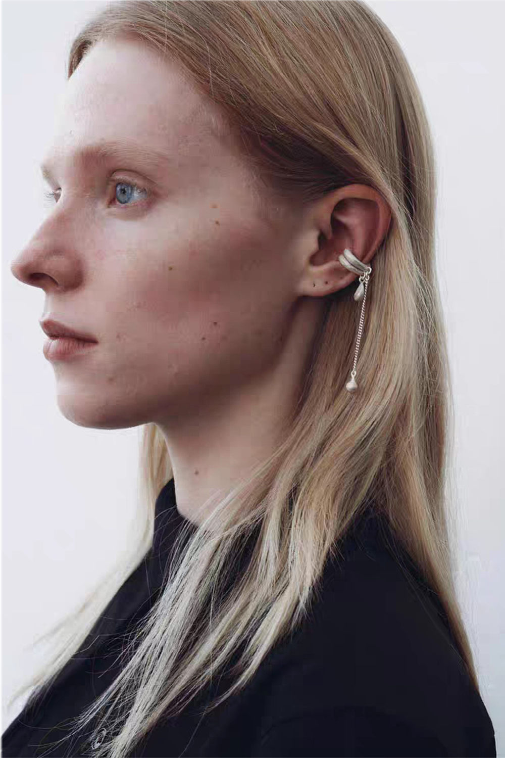 Whispering Droplets ear cuff on blonde - Black top, pearl earring pairing