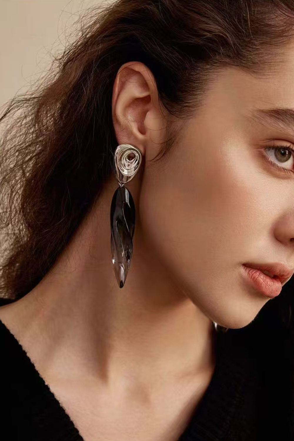 Brunette wearing swirl gradient earrings - Side profile, neutral backdrop​